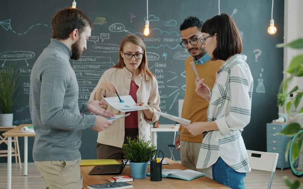 Diverse team collaborating on a project in an office